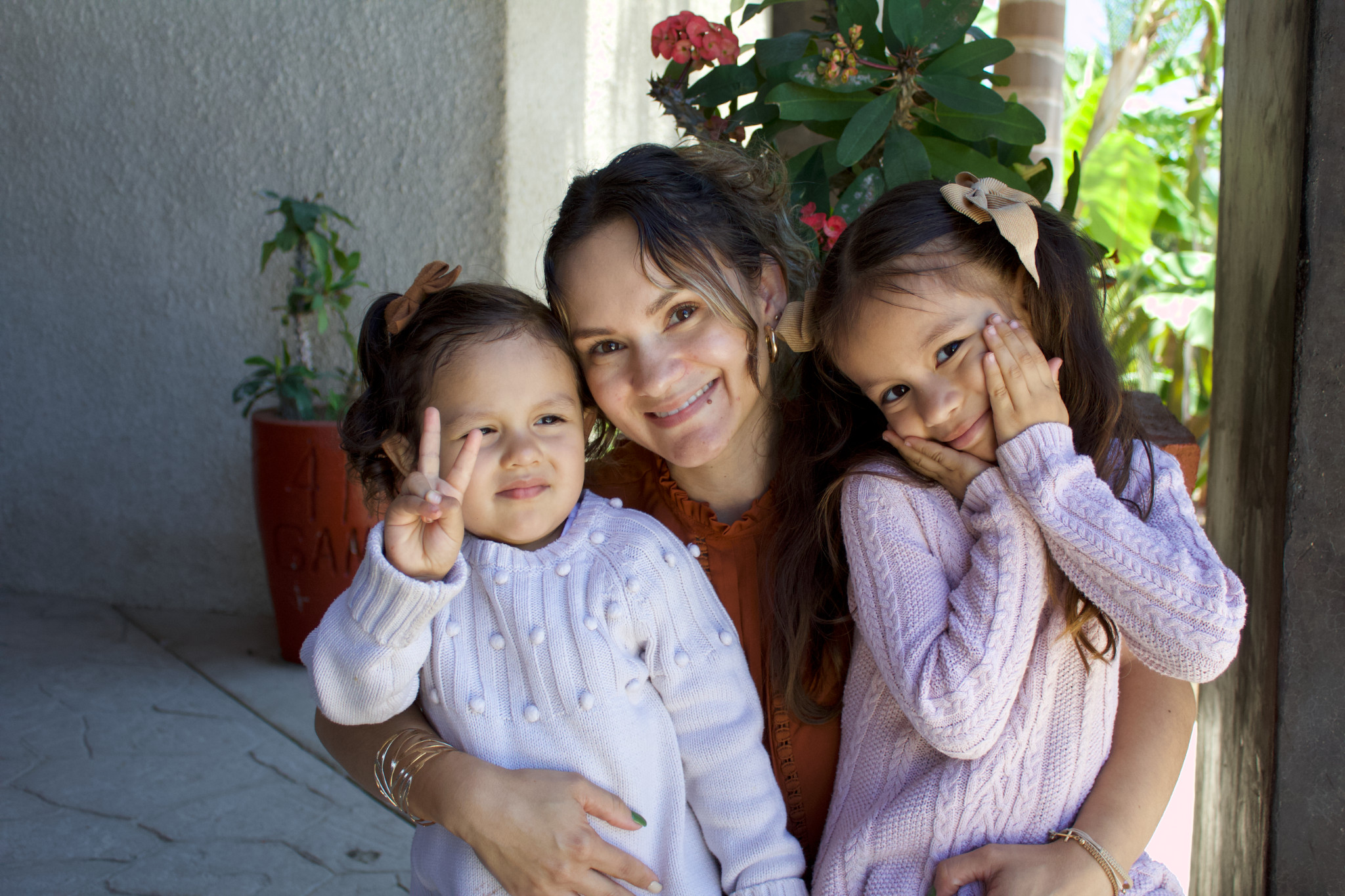 Mother and two daughters smiling together